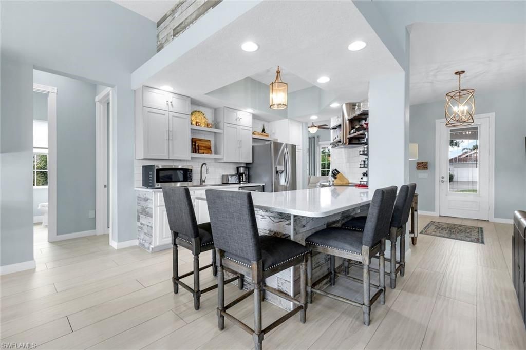 Dining room, Interior, Kitchen, Pendant Lights, Recessed Lighting, Stainless Steel Appliances, Wood Texture Flooring