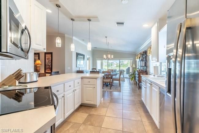 Chandelier, Dining room, Interior, Kitchen, Pendant Lights, Recessed Lighting, Stainless Steel Appliances