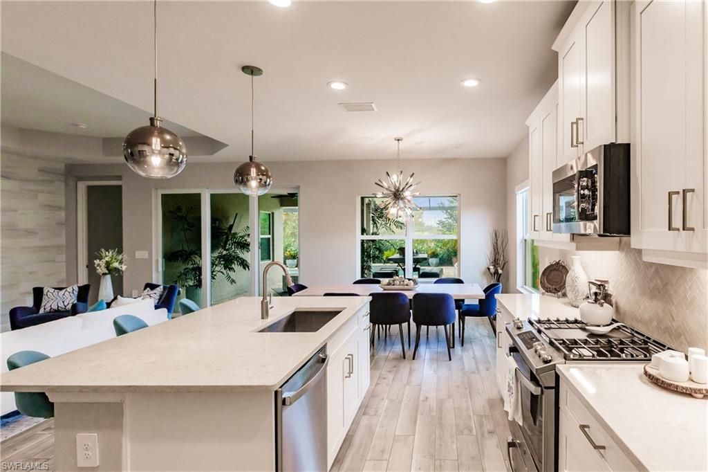 Dining room, Interior, Kitchen, Pendant Lights, Recessed Lighting, Stainless Steel Appliances, Wood Texture Flooring