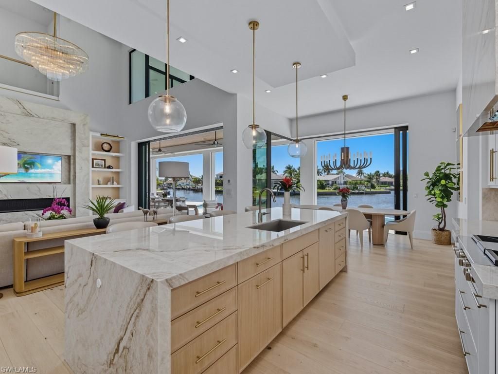 Chandelier, Dining room, Fireplace, Interior, Kitchen, Living room, Pendant Lights, Recessed Lighting, Water, Wood Texture Flooring