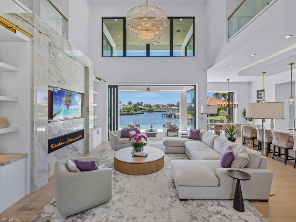 Chandelier, Dining room, Fireplace, Interior, Living room, Pendant Lights, Recessed Lighting, Water, Wood Texture Flooring