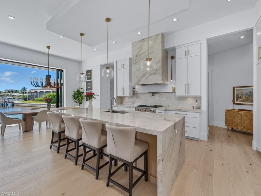 Interior, Kitchen, Marble Walls, Pendant Lights, Recessed Lighting, Stainless Steel Appliances, Water, Wood Texture Flooring