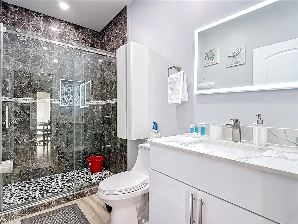 Bathroom, Glass Shower, Interior, Marble Walls, Recessed Lighting, Wood Texture Flooring
