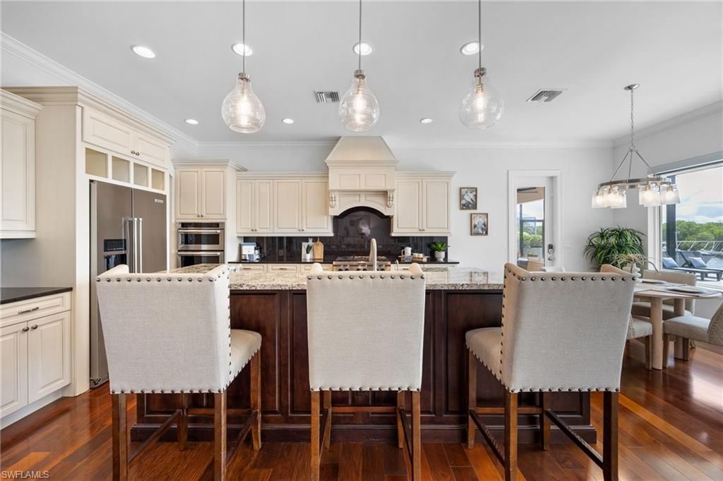 Dining room, Fireplace, Interior, Kitchen, Pendant Lights, Recessed Lighting, Stainless Steel Appliances, Wood Texture Flooring