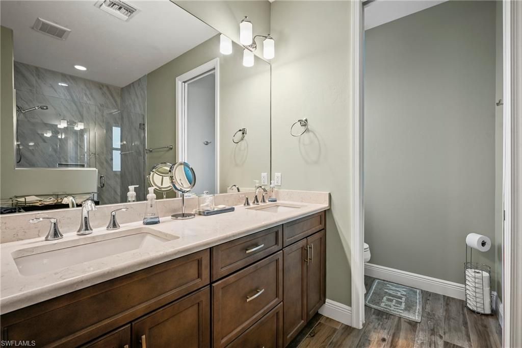Bathroom, Dual Sink Vanities, Interior, Marble Walls, Recessed Lighting, Wood Texture Flooring