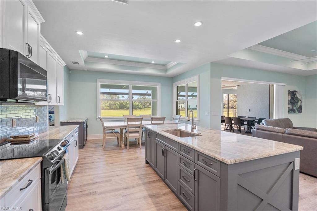 Dining room, Interior, Kitchen, Living room, Recessed Lighting, Stainless Steel Appliances, Wood Texture Flooring