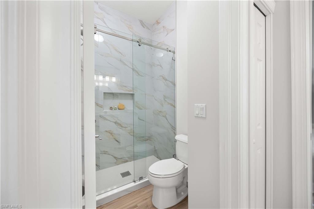 Bathroom, Glass Shower, Interior, Marble Walls, Wood Texture Flooring