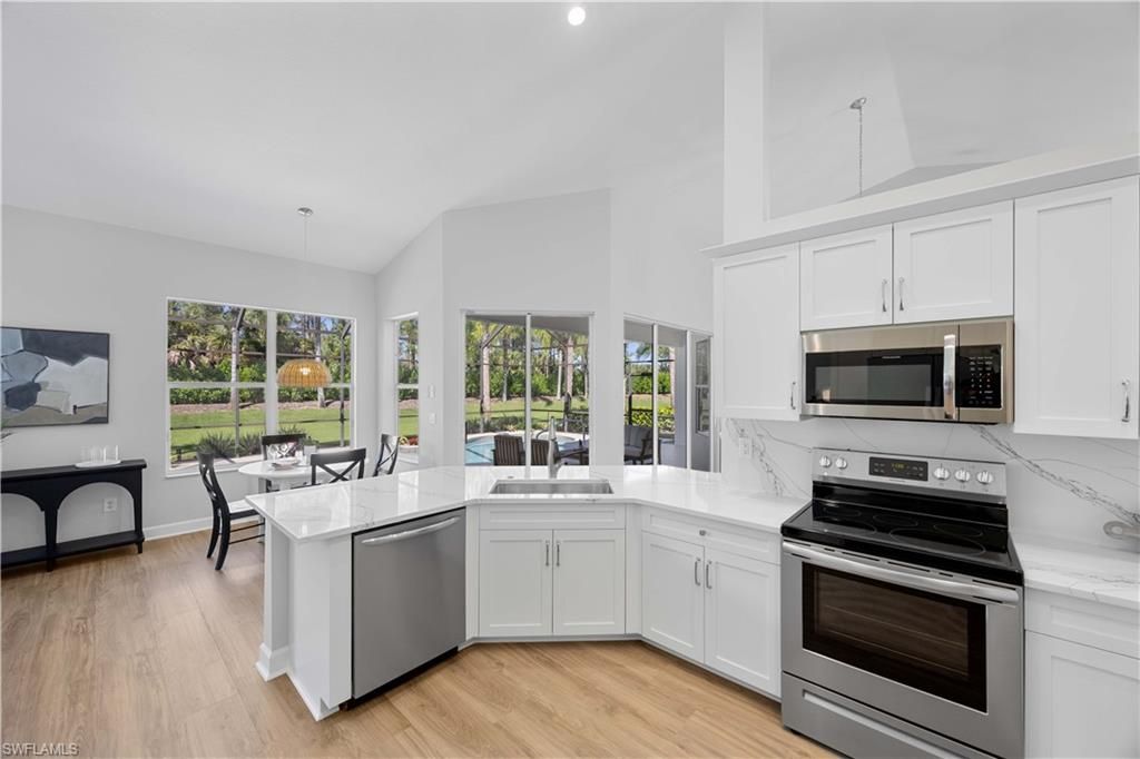 Dining room, Interior, Kitchen, Pendant Lights, Recessed Lighting, Stainless Steel Appliances, Wood Texture Flooring