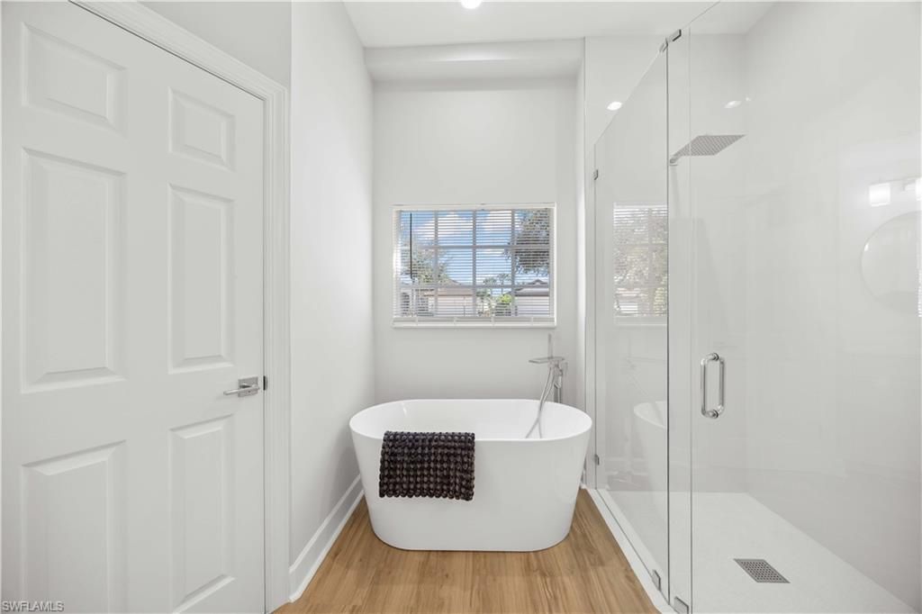 Bathroom, Free Standing Baths, Glass Shower, Interior, Recessed Lighting, Wood Texture Flooring