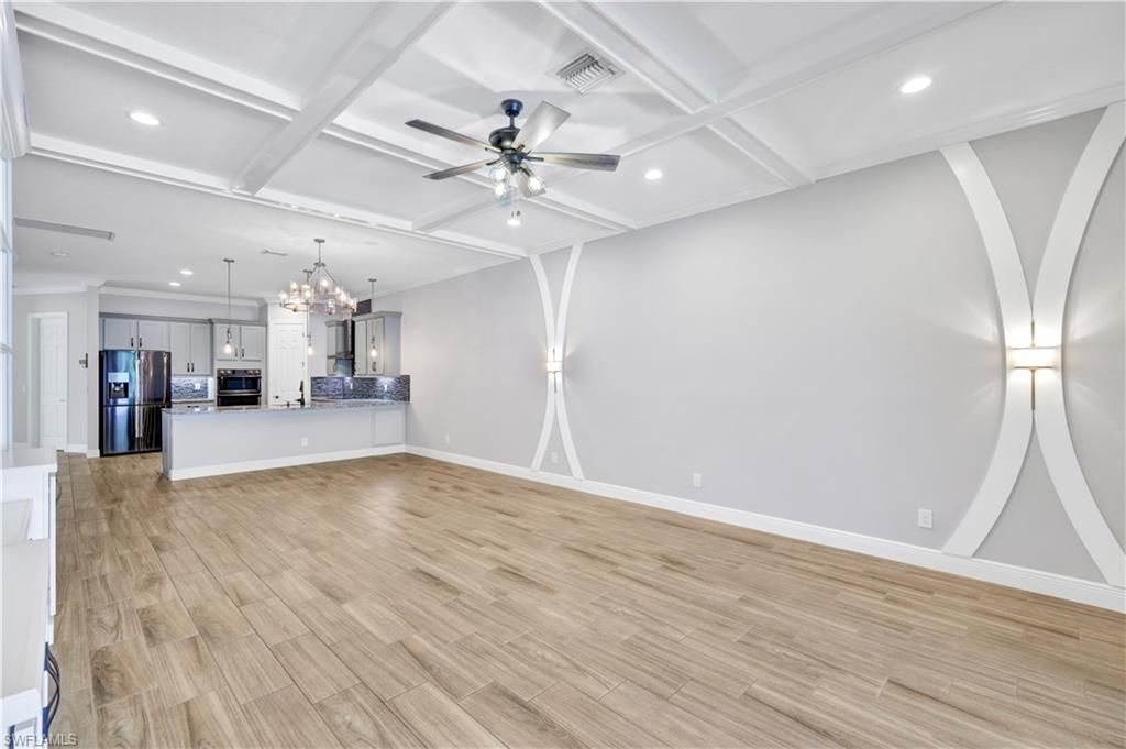 Chandelier, Empty room, Interior, Kitchen, Pendant Lights, Recessed Lighting, Stainless Steel Appliances, Wood Texture Flooring