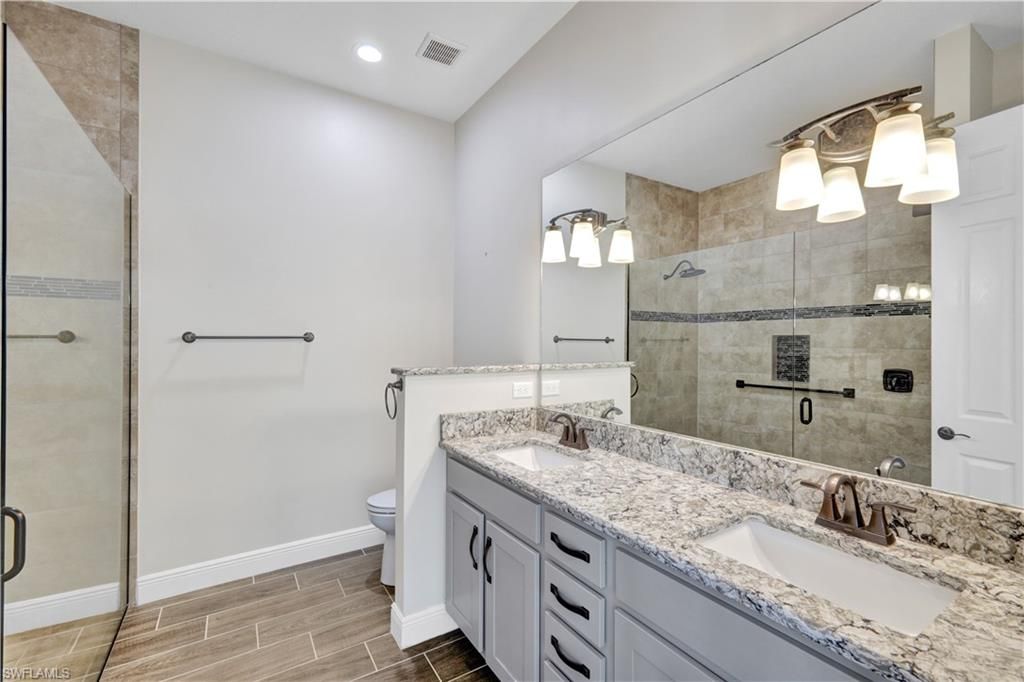 Bathroom, Dual Sink Vanities, Glass Shower, Interior, Recessed Lighting, Wood Texture Flooring