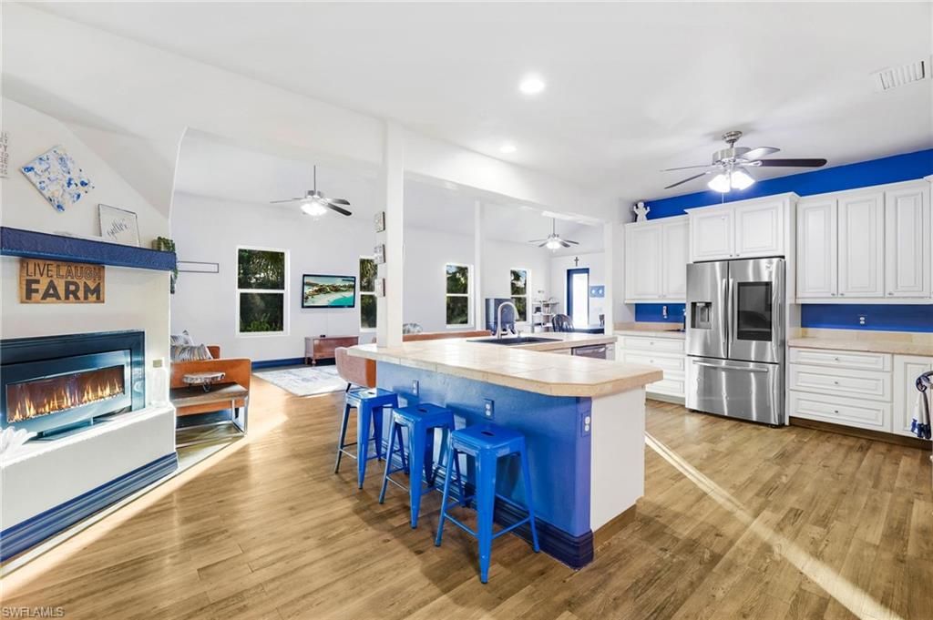 Fireplace, Interior, Kitchen, Recessed Lighting, Stainless Steel Appliances, Wood Texture Flooring