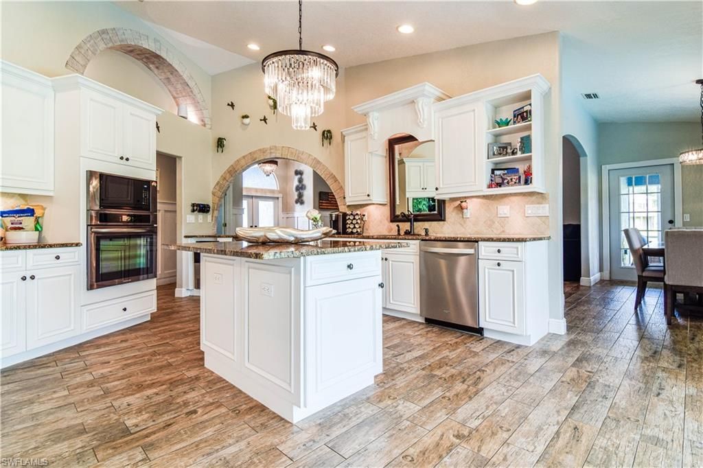 Chandelier, Dining room, Interior, Kitchen, Recessed Lighting, Stainless Steel Appliances, Wood Texture Flooring