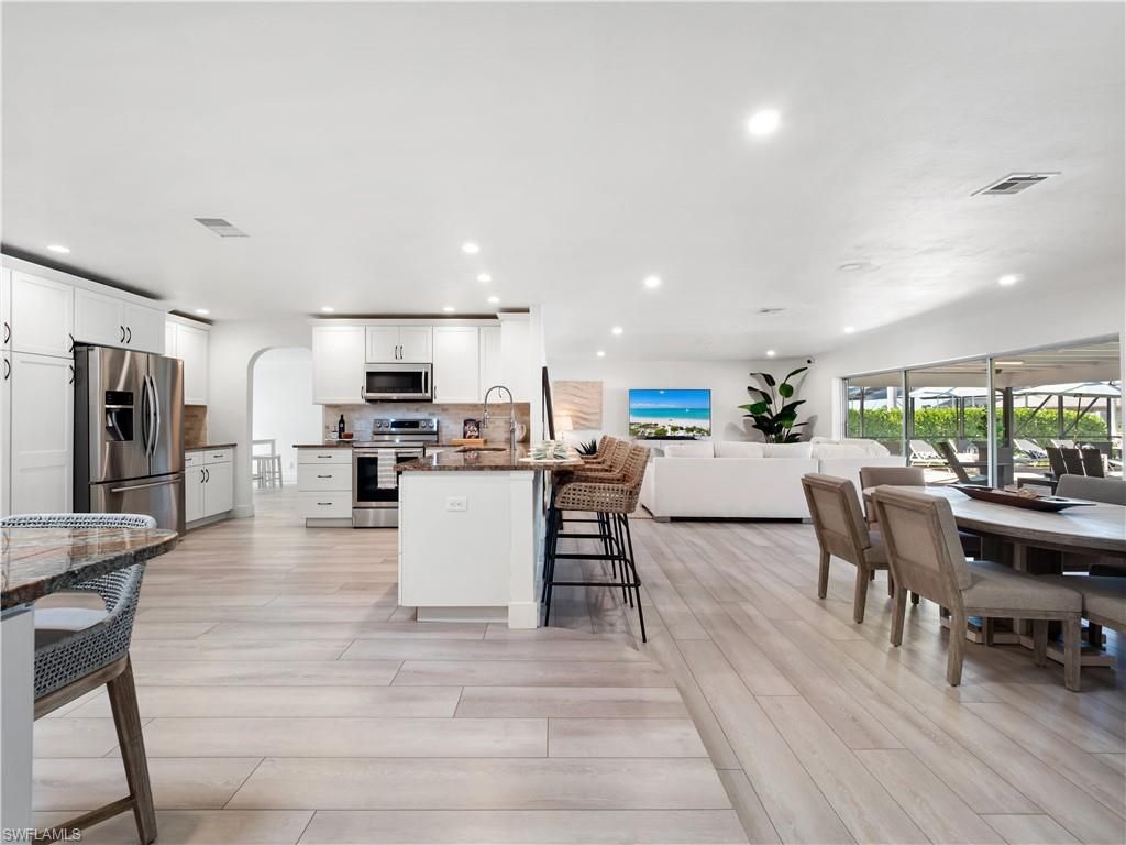 Dining room, Interior, Kitchen, Living room, Recessed Lighting, Stainless Steel Appliances, Wood Texture Flooring