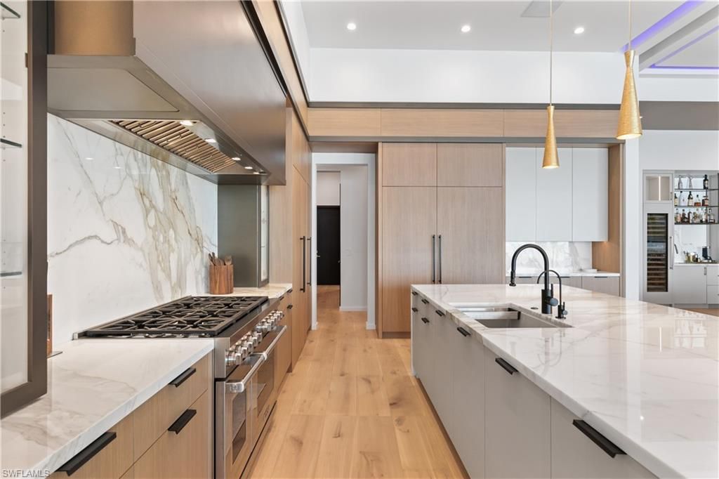 Interior, Kitchen, Marble Walls, Pendant Lights, Recessed Lighting, Stainless Steel Appliances, Wood Texture Flooring