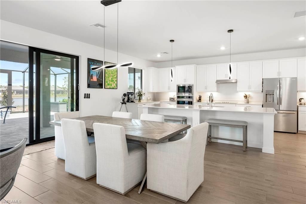 Dining room, Interior, Kitchen, Pendant Lights, Recessed Lighting, Stainless Steel Appliances, Wood Texture Flooring