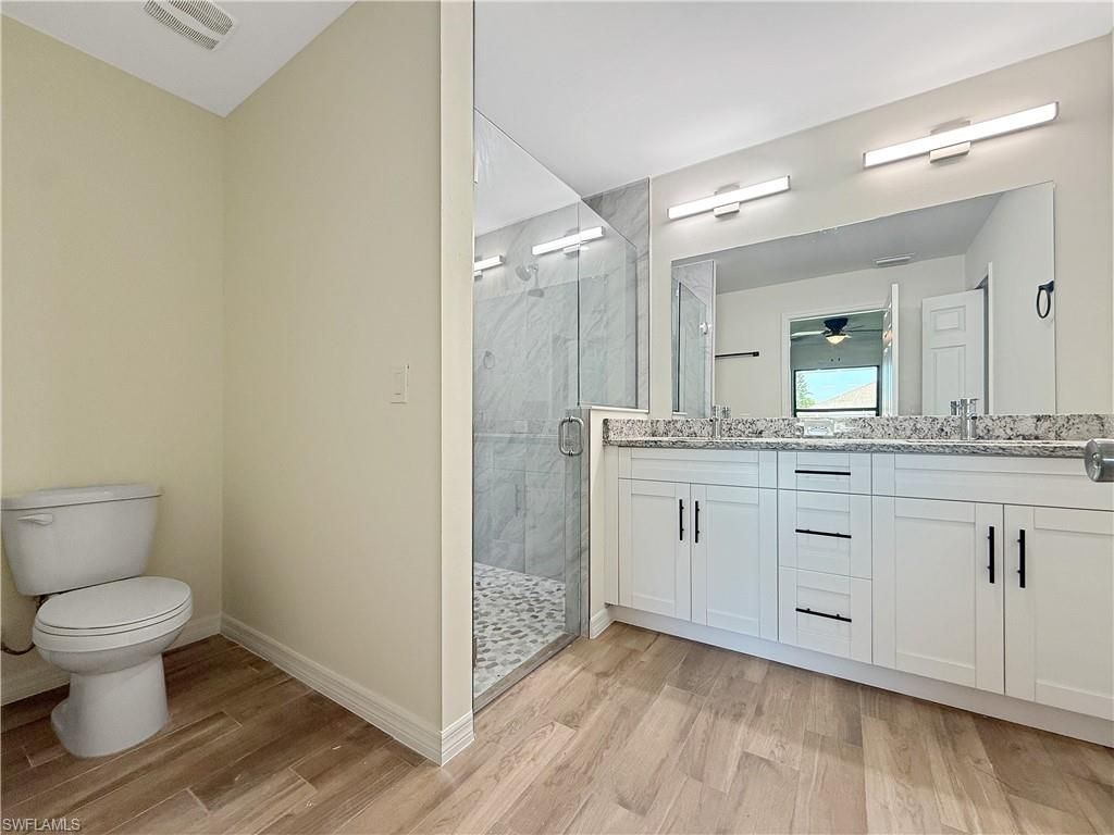 Bathroom, Dual Sink Vanities, Glass Shower, Interior, Marble Walls, Wood Texture Flooring