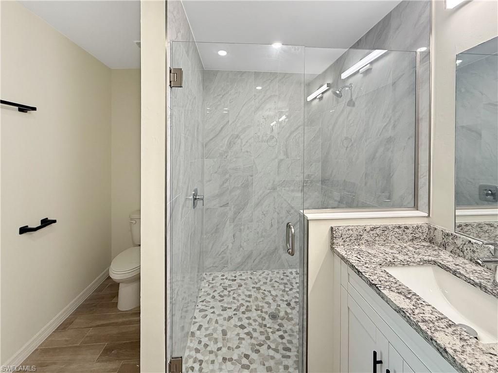 Bathroom, Glass Shower, Interior, Marble Walls, Recessed Lighting, Wood Texture Flooring