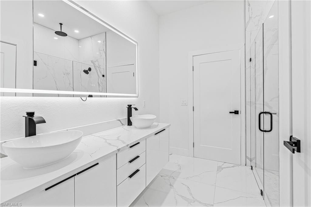 Bathroom, Dual Sink Vanities, Glass Shower, Interior, Marble, Marble Walls, Recessed Lighting