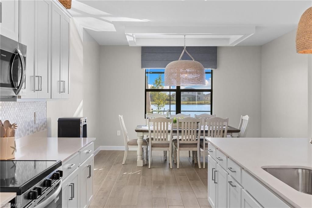Dining room, Interior, Kitchen, Pendant Lights, Stainless Steel Appliances, Water, Wood Texture Flooring