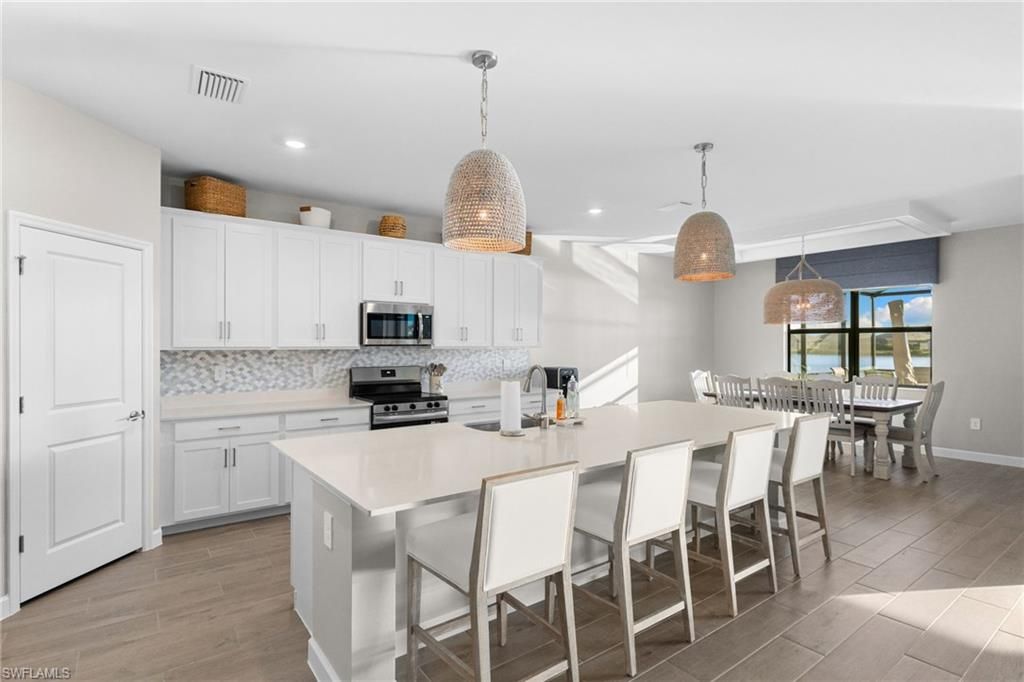 Dining room, Interior, Kitchen, Pendant Lights, Recessed Lighting, Stainless Steel Appliances, Wood Texture Flooring