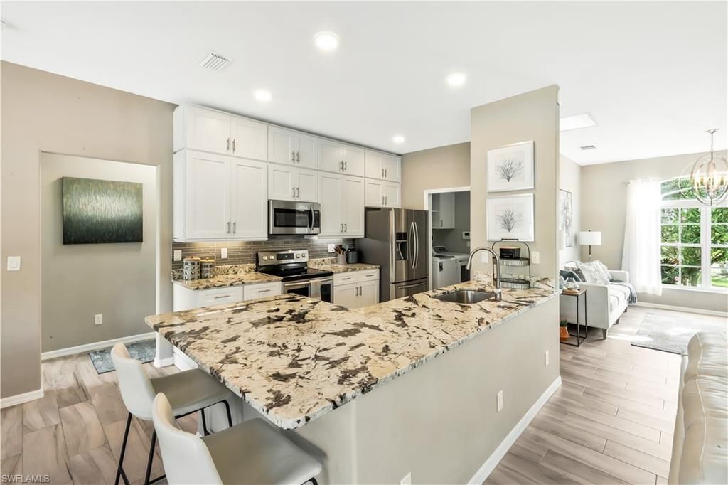 Chandelier, Interior, Kitchen, Living room, Recessed Lighting, Stainless Steel Appliances, Wood Texture Flooring