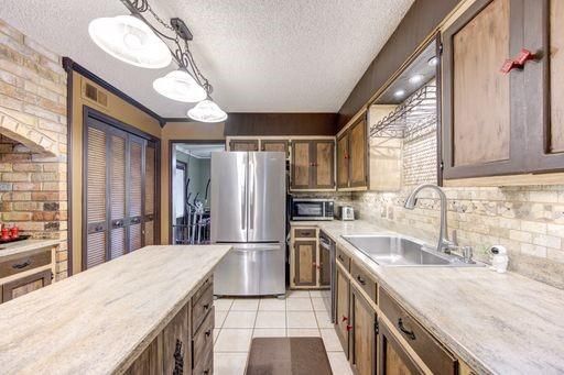 Interior, Kitchen, Pendant Lights, Stainless Steel Appliances, Stone Walls