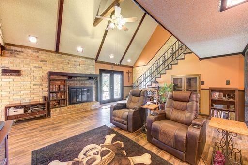Fireplace, Interior, Living room, Recessed Lighting, Stone Walls, Wood Texture Flooring