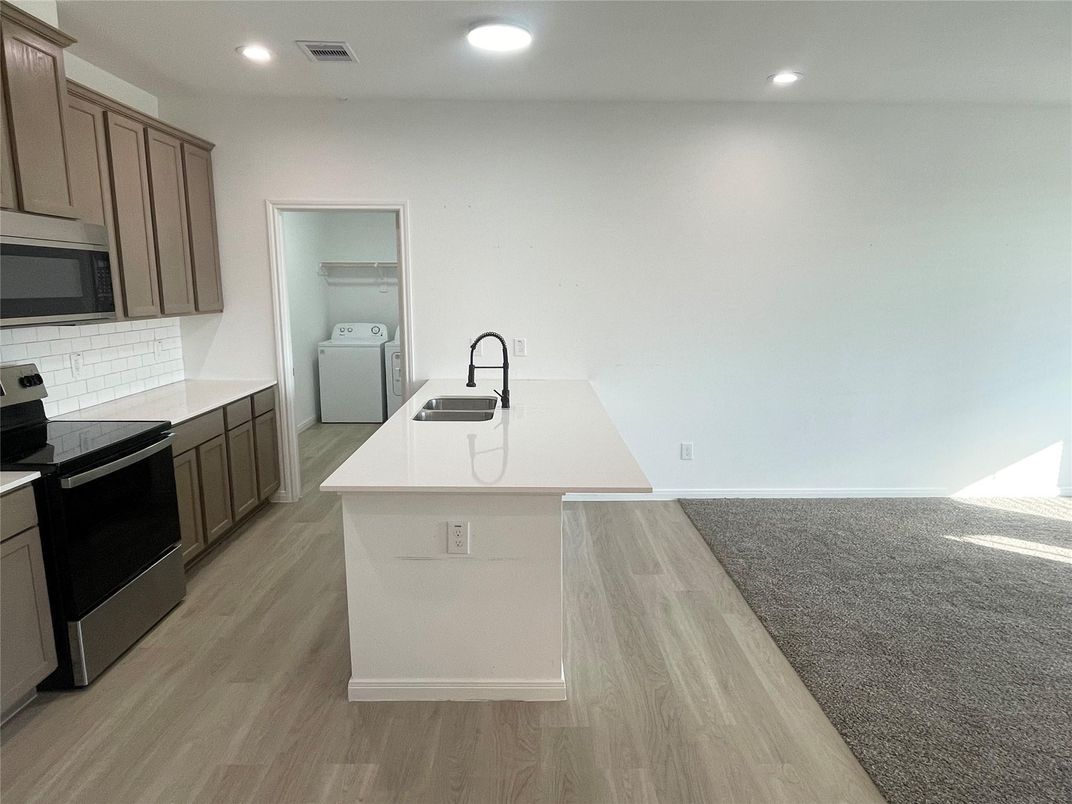 Interior, Kitchen, Recessed Lighting, Washer, Wood Texture Flooring