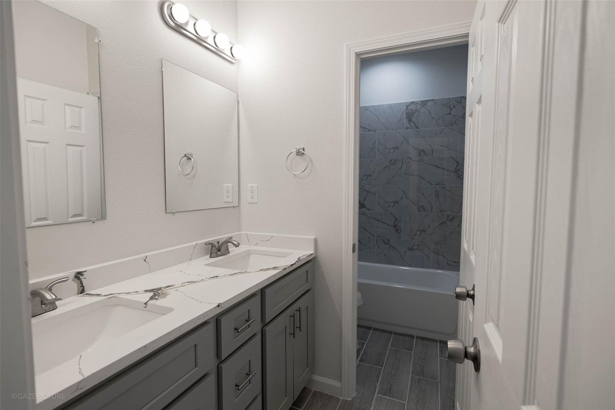 Bathroom, Dual Sink Vanities, Interior, Marble Walls, Wood Texture Flooring