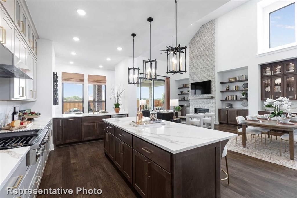 Dining room, Fireplace, Interior, Kitchen, Pendant Lights, Recessed Lighting, Stainless Steel Appliances, Stone Walls, Wood Texture Flooring