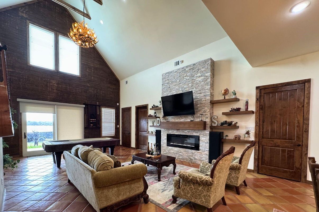 Billiard Table, Chandelier, Fireplace, Game Room, Interior, Living room, Recessed Lighting, Stone Walls, Wood Texture Flooring