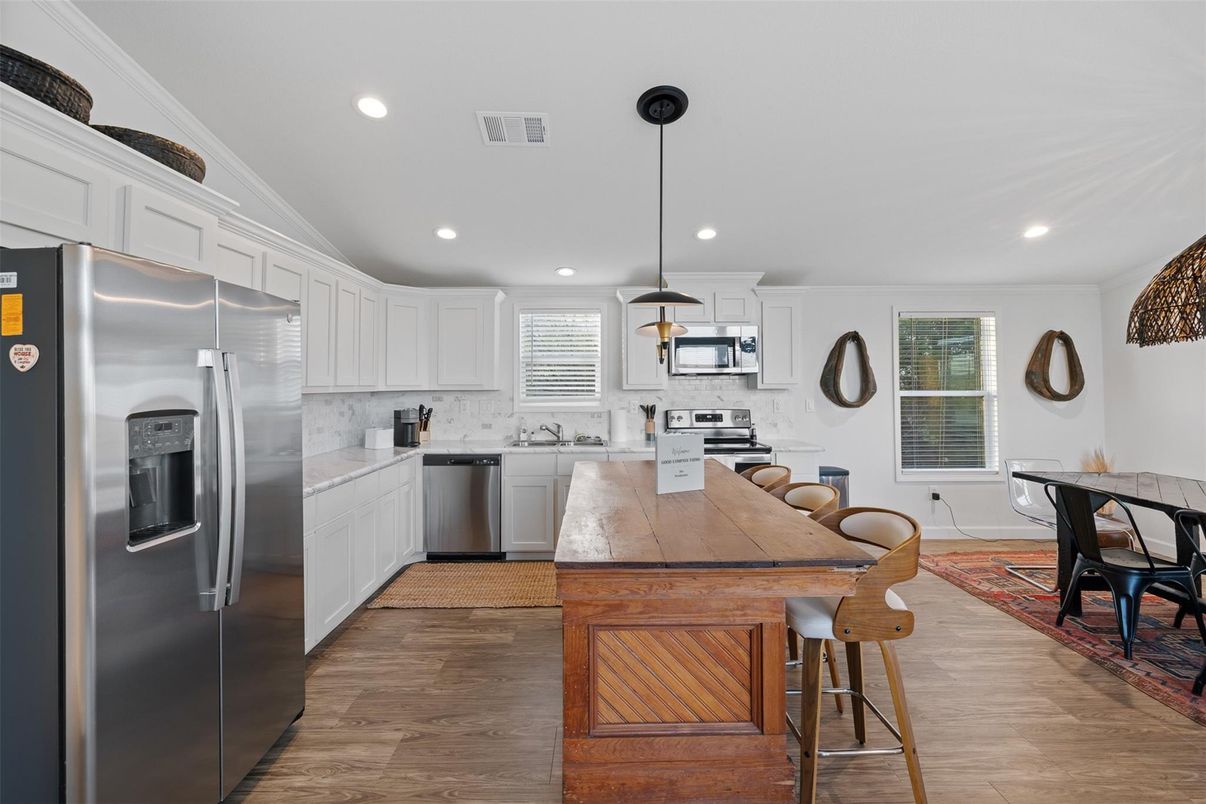 Dining room, Interior, Kitchen, Pendant Lights, Recessed Lighting, Stainless Steel Appliances, Wood Texture Flooring