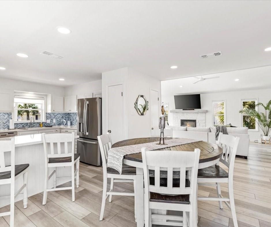 Dining room, Fireplace, Interior, Kitchen, Living room, Recessed Lighting, Stainless Steel Appliances, Wood Texture Flooring