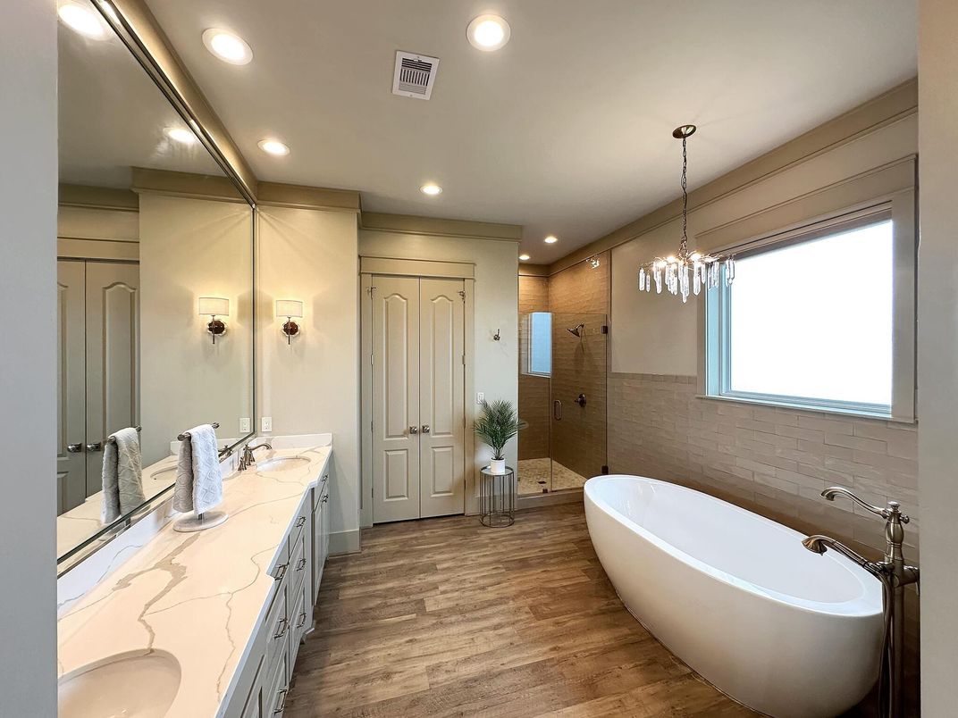 Bathroom, Chandelier, Dual Sink Vanities, Free Standing Baths, Interior, Pendant Lights, Recessed Lighting, Wood Texture Flooring