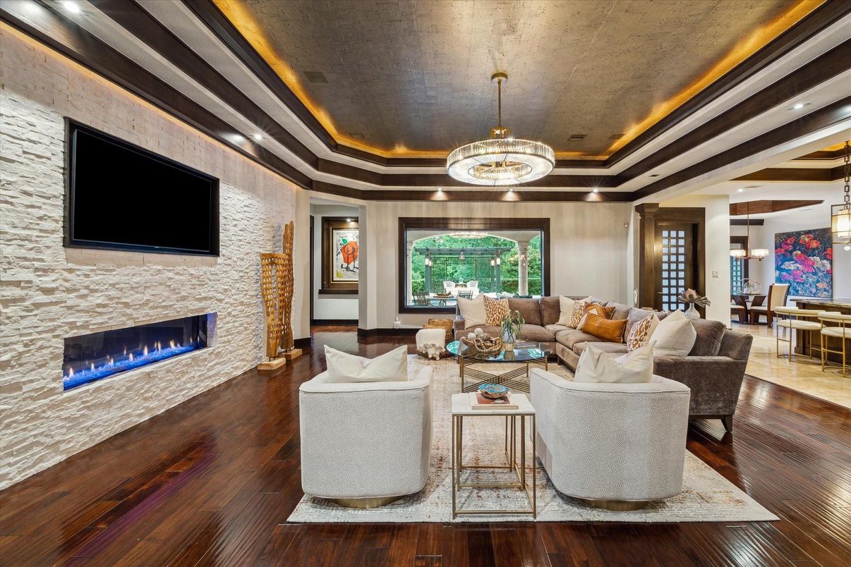 Chandelier, Dining room, Fireplace, Interior, Living room, Pendant Lights, Recessed Lighting, Stone Walls, Wood Texture Flooring