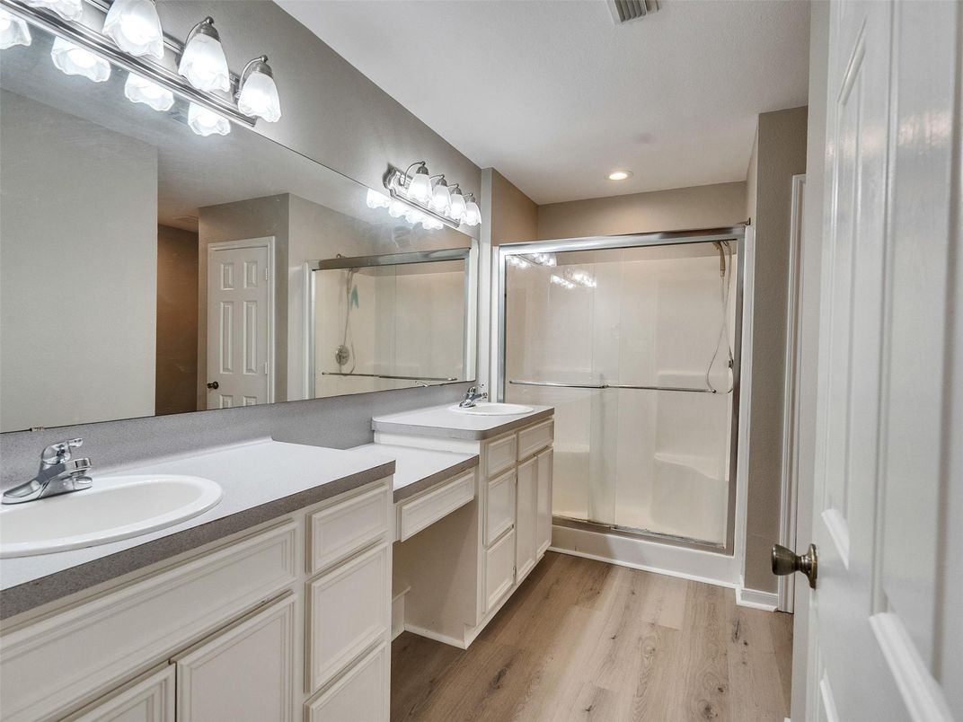 Bathroom, Dual Sink Vanities, Glass Shower, Interior, Recessed Lighting, Wood Texture Flooring