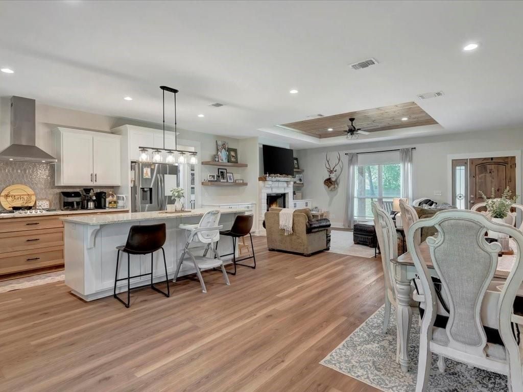 Dining room, Fireplace, Interior, Kitchen, Living room, Pendant Lights, Recessed Lighting, Stainless Steel Appliances, Wood Texture Flooring
