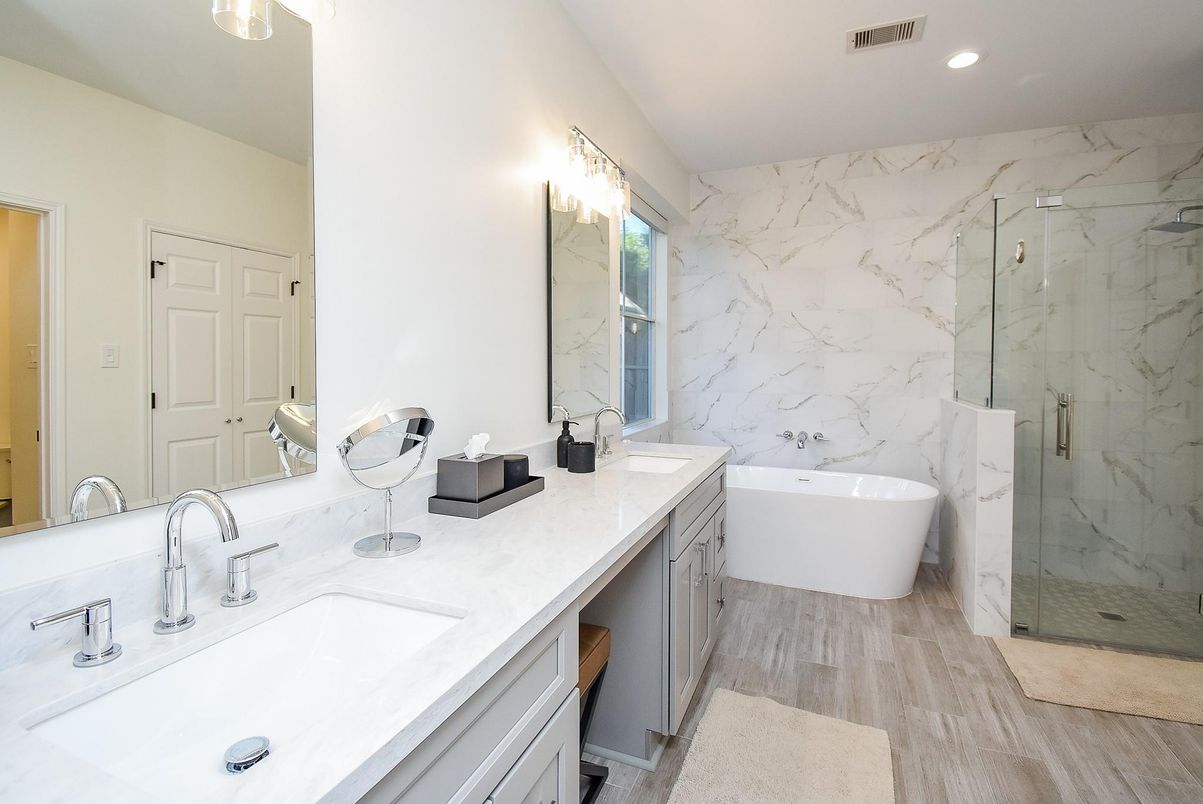 Bathroom, Dual Sink Vanities, Free Standing Baths, Glass Shower, Interior, Marble Walls, Recessed Lighting, Wood Texture Flooring