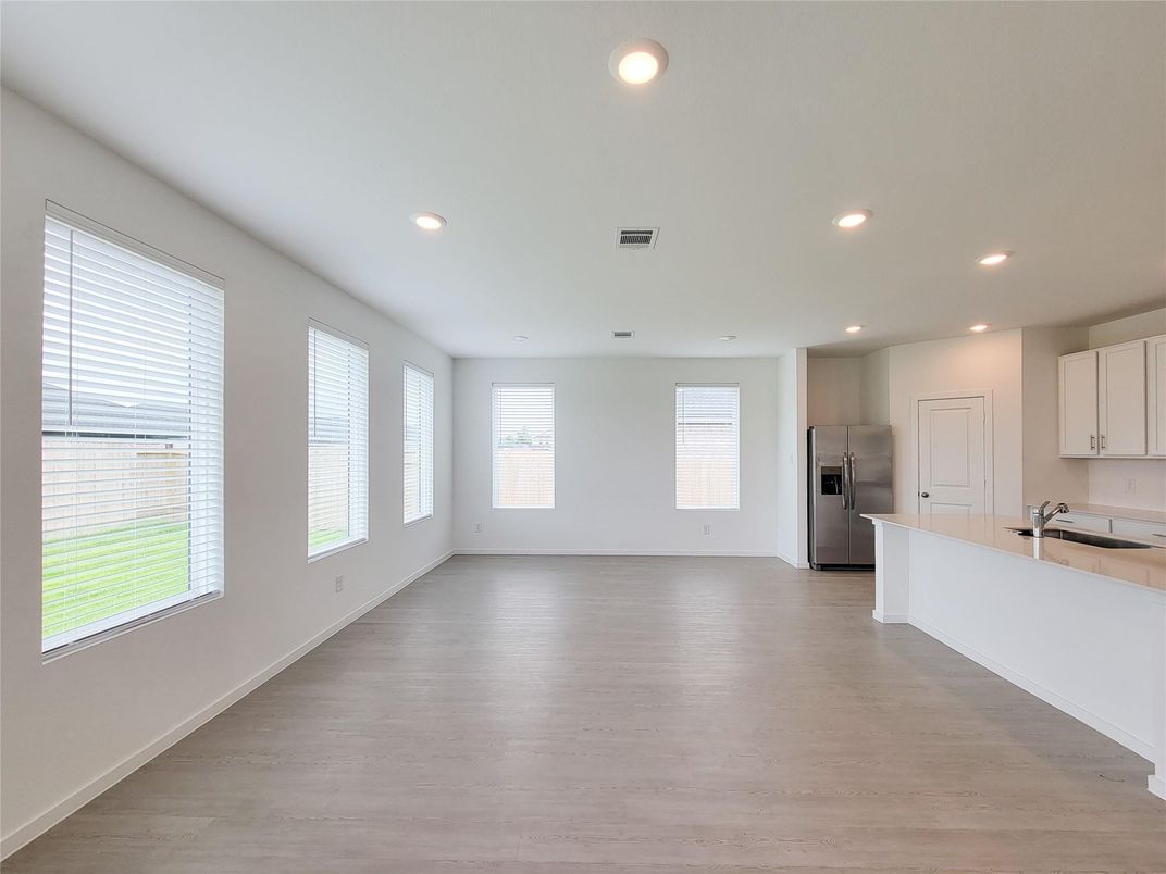 Empty room, Interior, Kitchen, Recessed Lighting, Stainless Steel Appliances, Wood Texture Flooring