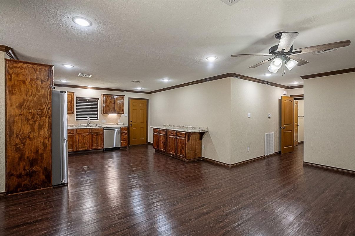 Empty room, Interior, Kitchen, Recessed Lighting, Stainless Steel Appliances, Wood Texture Flooring