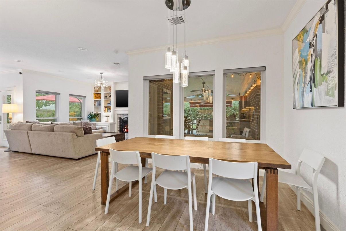 Chandelier, Dining room, Fireplace, Interior, Living room, Pendant Lights, Recessed Lighting, Wood Texture Flooring