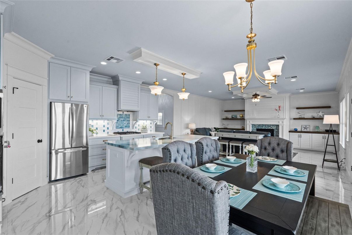 Chandelier, Dining room, Fireplace, Interior, Kitchen, Living room, Marble, Pendant Lights, Recessed Lighting, Stainless Steel Appliances