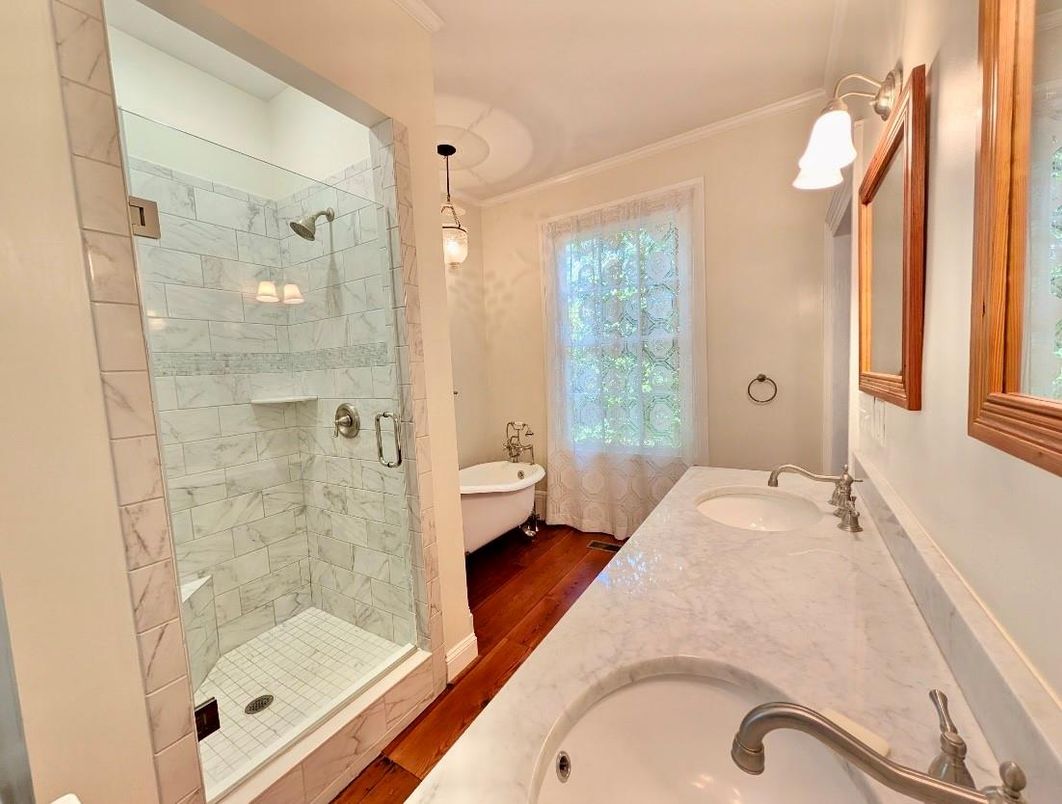 Bathroom, Dual Sink Vanities, Glass Shower, Interior, Marble Walls, Wood Texture Flooring