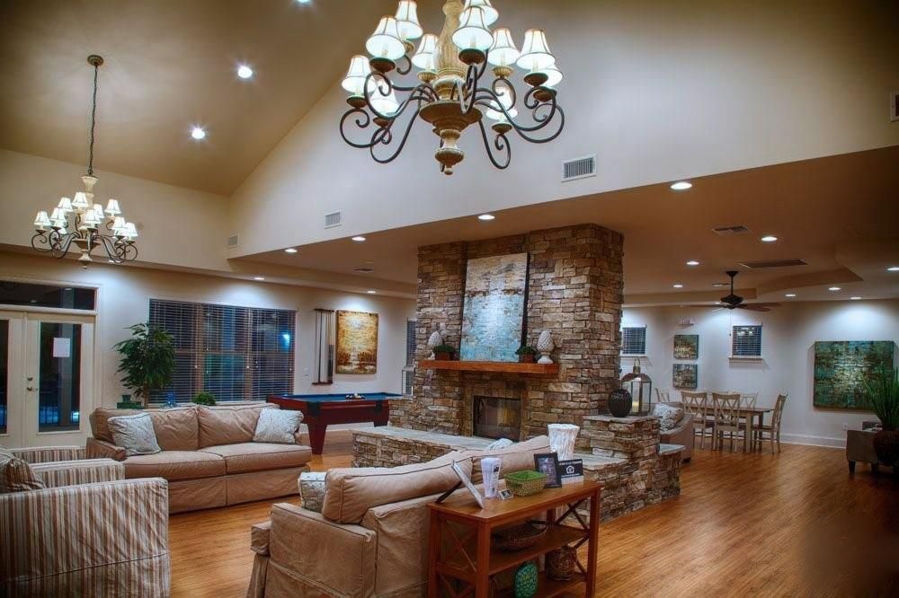 Billiard Table, Chandelier, Dining room, Fireplace, Game Room, Interior, Living room, Recessed Lighting, Stone Walls, Wood Texture Flooring