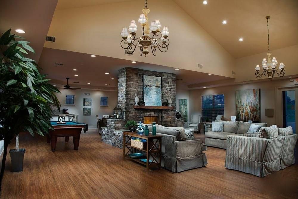 Billiard Table, Chandelier, Fireplace, Game Room, Interior, Living room, Recessed Lighting, Stone Walls, Wood Texture Flooring