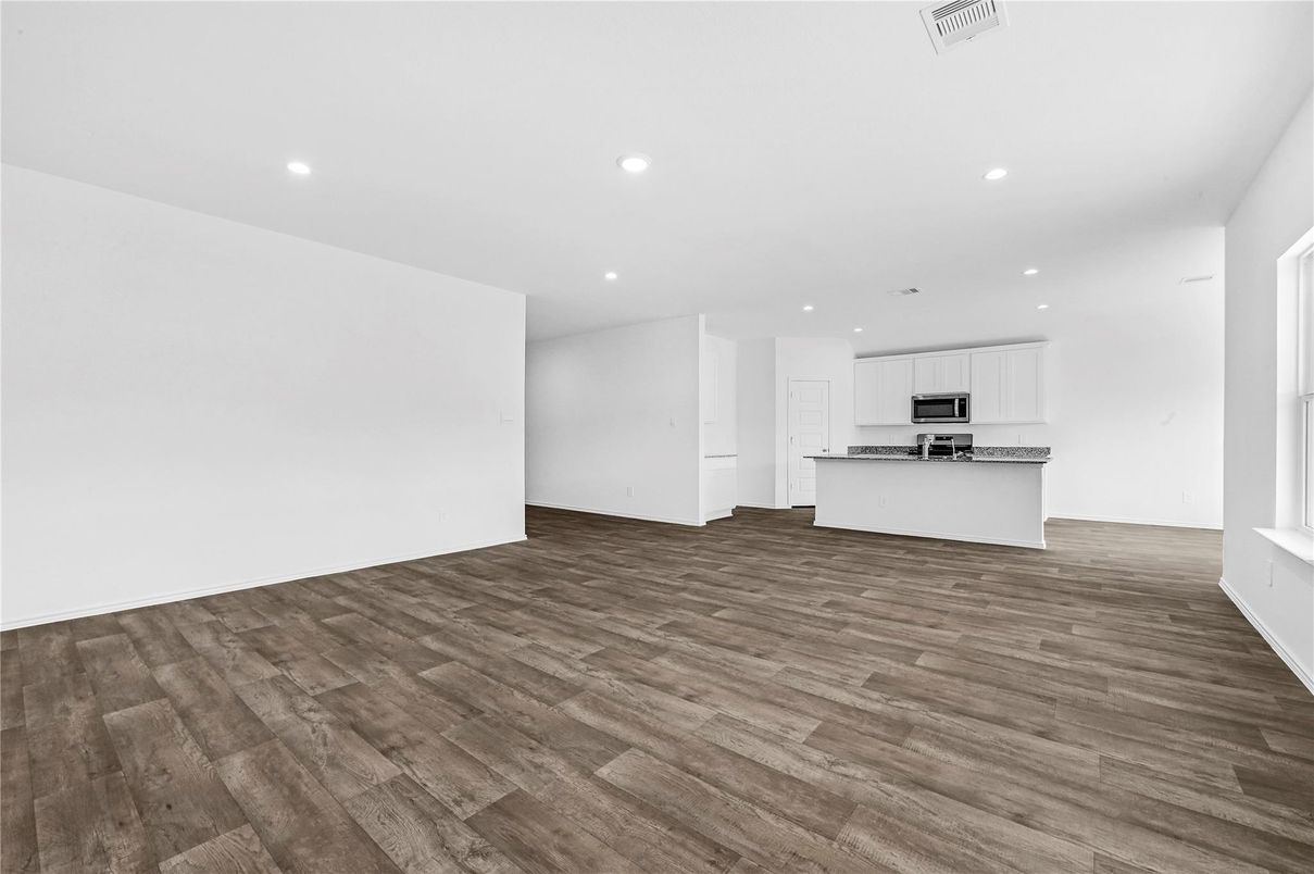 Empty room, Interior, Kitchen, Recessed Lighting, Stainless Steel Appliances, Wood Texture Flooring