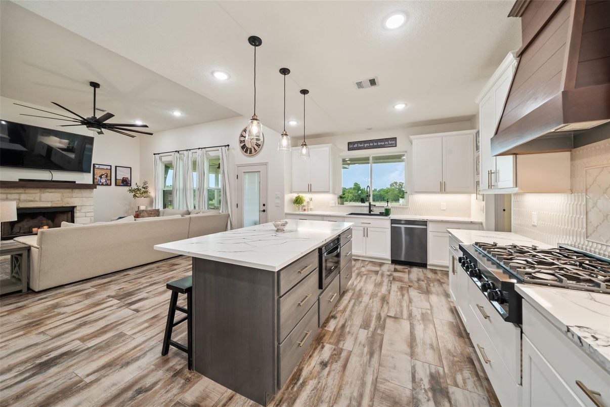 Fireplace, Interior, Kitchen, Living room, Pendant Lights, Recessed Lighting, Stainless Steel Appliances, Wood Texture Flooring
