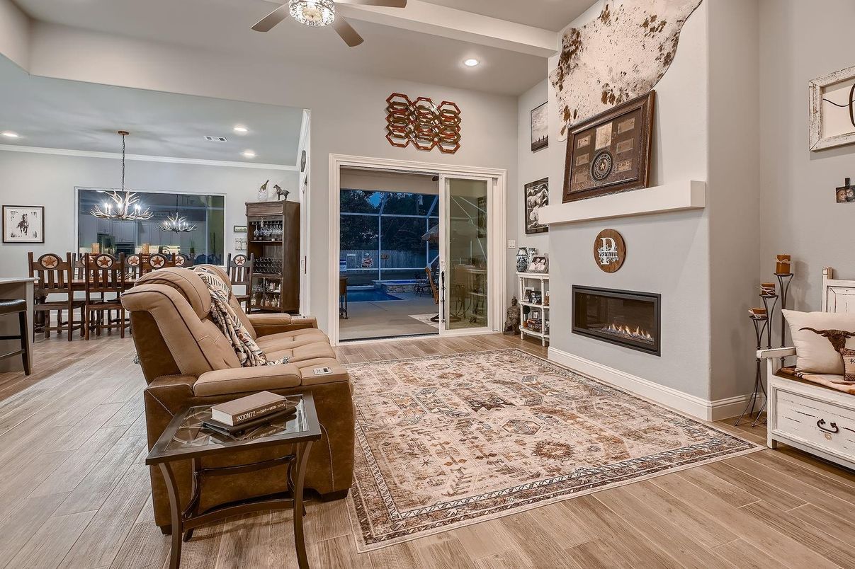 Chandelier, Dining room, Fireplace, Interior, Living room, Pendant Lights, Recessed Lighting, Wood Texture Flooring
