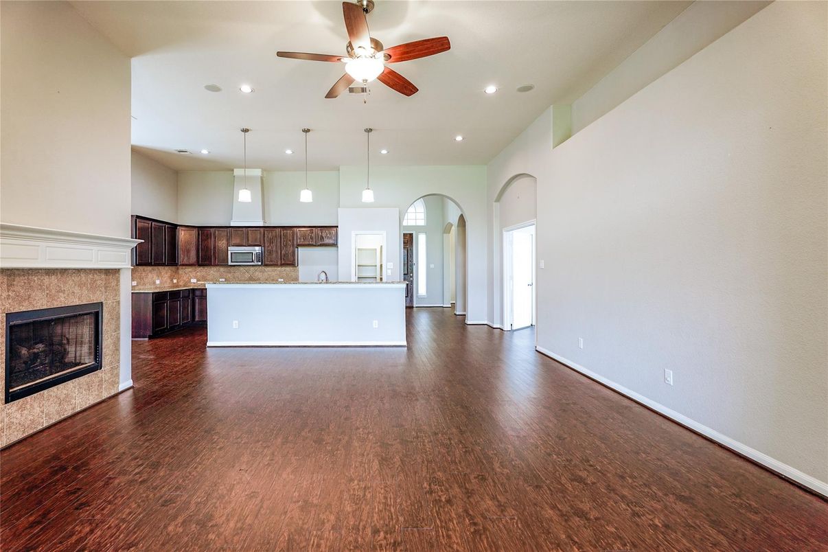 Empty room, Fireplace, Interior, Kitchen, Pendant Lights, Recessed Lighting, Wood Texture Flooring